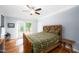 Spacious bedroom featuring hardwood floors and a ceiling fan with access to an outdoor deck at 698 Maple Springs Ln, Bear Creek, NC 27207