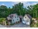 Aerial view of charming home with lush greenery and an attached two-car garage at 698 Maple Springs Ln, Bear Creek, NC 27207