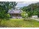 Well landscaped home with a cozy front porch, lush lawn, and a rustic split rail fence at 698 Maple Springs Ln, Bear Creek, NC 27207