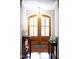 Sunlit foyer with wood floors and a beautiful stained wood front door at 698 Maple Springs Ln, Bear Creek, NC 27207