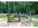 Backyard garden with a wooden fence, raised beds, and greenery at 698 Maple Springs Ln, Bear Creek, NC 27207