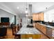 This well-lit kitchen has granite countertops, stainless steel appliances and a large island perfect for cooking and entertaining at 698 Maple Springs Ln, Bear Creek, NC 27207