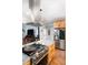 Open kitchen with stainless steel appliances, granite countertops, island and a view to the dining and living areas at 698 Maple Springs Ln, Bear Creek, NC 27207