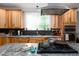 Bright kitchen featuring wood cabinets, granite countertops, and an island with cooktop and stainless steel hood at 698 Maple Springs Ln, Bear Creek, NC 27207