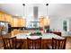 Bright kitchen with an island, light wood cabinets, and stainless steel appliances including a modern oven and a refrigerator at 698 Maple Springs Ln, Bear Creek, NC 27207