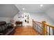Hardwood flooring and wood and metal railing at the top of the stairs at 698 Maple Springs Ln, Bear Creek, NC 27207