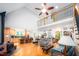 Open living space with hardwood floors, a wood-burning stove, and an open stairway to the second level at 698 Maple Springs Ln, Bear Creek, NC 27207
