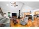 Sun-filled living room with wood floors and access to the kitchen at 698 Maple Springs Ln, Bear Creek, NC 27207