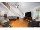 Spacious living room with vaulted ceilings, hardwood floors, and a staircase with wrought iron railings at 698 Maple Springs Ln, Bear Creek, NC 27207