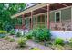 Inviting porch with a wood ceiling, ceiling fans, railings, and brick pathway at 698 Maple Springs Ln, Bear Creek, NC 27207