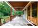 Wide, covered porch featuring stained wood columns, stained wood ceiling and outdoor seating area at 698 Maple Springs Ln, Bear Creek, NC 27207