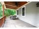 Outdoor patio with gray flooring, a wood ceiling and a table and chairs for relaxing at 698 Maple Springs Ln, Bear Creek, NC 27207