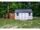 Well-kept garden shed with a coop attached is nestled in a wooded area at 698 Maple Springs Ln, Bear Creek, NC 27207