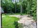 Expansive backyard with mature trees, green grass, and a garden area at 698 Maple Springs Ln, Bear Creek, NC 27207