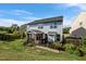 View of the backyard and screened-in porch with a patio and neatly landscaped yard at 7 Faircroft Ct, Durham, NC 27703