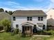 Back exterior view of a two-story home with screened porch and patio with a Duke-branded grill at 7 Faircroft Ct, Durham, NC 27703