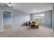Bright bedroom with carpet flooring, a large window, and comfortable seating area at 7 Faircroft Ct, Durham, NC 27703
