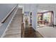Open-concept entryway with hardwood floors, staircase and adjacent dining room at 7 Faircroft Ct, Durham, NC 27703
