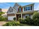 A beautiful two-story home featuring stone accents, a two-car garage, and mature landscaping at 7 Faircroft Ct, Durham, NC 27703