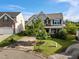 Charming two-story home with shaker and stone accents, a mature tree in the front yard, and landscaping at 7 Faircroft Ct, Durham, NC 27703
