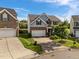 Charming two-story home with stone and shaker accents and a well-kept yard, near another home at 7 Faircroft Ct, Durham, NC 27703