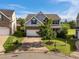 Two-story home with stone and shaker accents, showcasing a tree in the front yard, next to another house at 7 Faircroft Ct, Durham, NC 27703