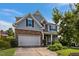 A charming two-story home features a two-car garage and a combination of stone and siding exterior at 7 Faircroft Ct, Durham, NC 27703