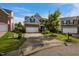 A two-story home featuring stone accents, neutral siding, and a well maintained lawn at 7 Faircroft Ct, Durham, NC 27703