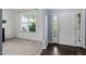 Bright foyer featuring white walls, a modern door and a view of a window at 7 Faircroft Ct, Durham, NC 27703