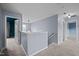 Upstairs hallway with access to bedrooms and a view of the stairwell chandelier at 7 Faircroft Ct, Durham, NC 27703