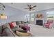 Spacious living room featuring a fireplace and a comfortable L-shaped sofa with accent pillows at 7 Faircroft Ct, Durham, NC 27703