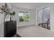 Inviting living room with neutral carpet, window views and an arched entryway at 7 Faircroft Ct, Durham, NC 27703