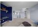 Spacious loft area with carpet, blue accent wall, and a decorative chandelier at 7 Faircroft Ct, Durham, NC 27703