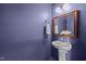 Cozy powder room features pedestal sink, gold-trimmed mirror, and a decorative wall finish at 7 Faircroft Ct, Durham, NC 27703