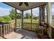 Enjoy this screened porch with backyard views, ceiling fan, and decorative curtains at 7 Faircroft Ct, Durham, NC 27703