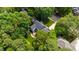 Beautiful home nestled among lush green trees with a well-manicured lawn and inviting outdoor space at 7620 Rainwater Rd, Raleigh, NC 27615
