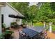 Inviting outdoor deck area with ample seating and lush green foliage in the background at 7620 Rainwater Rd, Raleigh, NC 27615