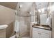 Bright bathroom with a tile shower featuring glass door and marble-topped vanity at 7620 Rainwater Rd, Raleigh, NC 27615