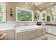 Bright bathroom with a soaking tub under a window with a beautiful view at 7620 Rainwater Rd, Raleigh, NC 27615