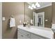 Bathroom features a light vanity, gold fixtures and a very large mirror at 7620 Rainwater Rd, Raleigh, NC 27615