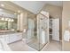 Bright bathroom featuring a glass shower, vanity, and doorway leading to the main bedroom at 7620 Rainwater Rd, Raleigh, NC 27615