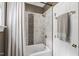 Bathroom with a tub and shower featuring a patterned tile accent and shower curtain at 7620 Rainwater Rd, Raleigh, NC 27615
