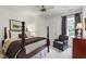 This bedroom features a four poster bed, a ceiling fan, and a sitting area at 7620 Rainwater Rd, Raleigh, NC 27615