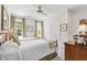 This bedroom features two twin beds, neutral walls, and an overhead ceiling fan at 7620 Rainwater Rd, Raleigh, NC 27615