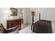 This bedroom features a four poster bed, a dresser, and a doorway leading to the bathroom at 7620 Rainwater Rd, Raleigh, NC 27615