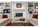Close up of the living room fireplace with sofas, glass table and red rug at 7620 Rainwater Rd, Raleigh, NC 27615