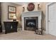 Cozy fireplace features mantle, marble surround, and wood storage area at 7620 Rainwater Rd, Raleigh, NC 27615