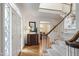 Elegant foyer with hardwood floors, staircase, and decorative glass door at 7620 Rainwater Rd, Raleigh, NC 27615