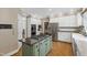 Open concept kitchen with center island and modern stainless steel appliances at 7620 Rainwater Rd, Raleigh, NC 27615