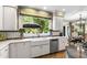 Kitchen sink beneath large window overlooking landscaped yard and open to eat-in area at 7620 Rainwater Rd, Raleigh, NC 27615